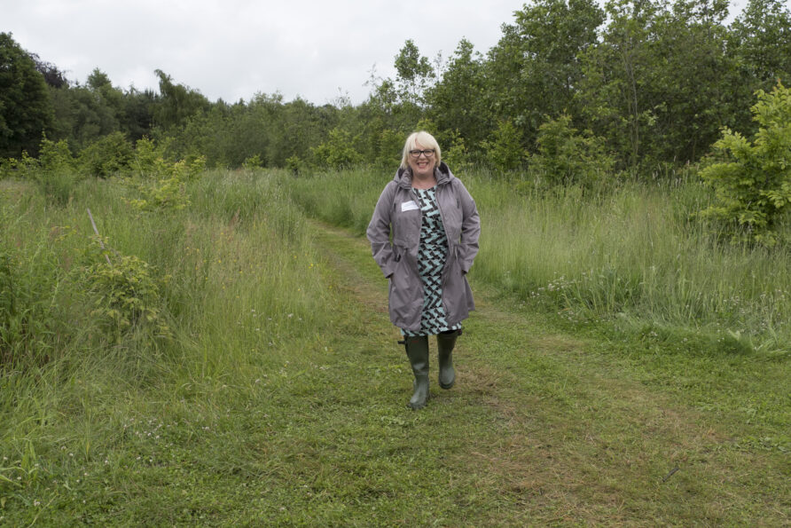 Lady walking in a meadow