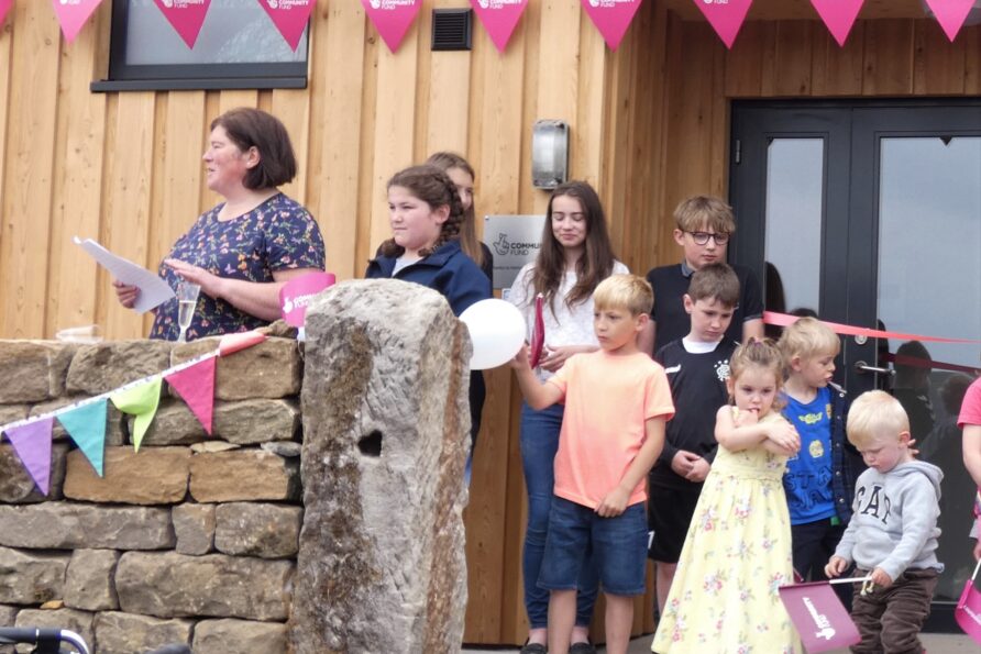 event day- group of t children outside entrance to community centre