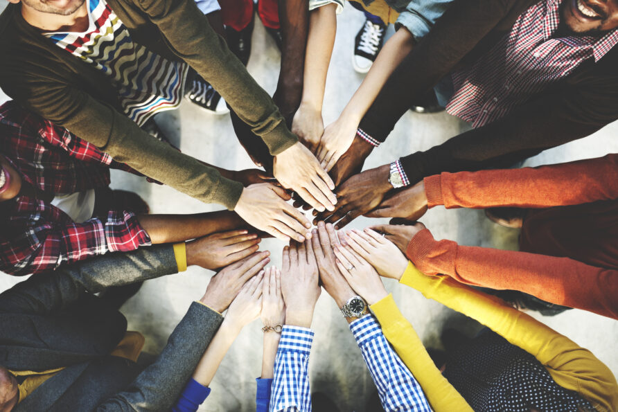 group of overlapping hands demonstrating teamwork