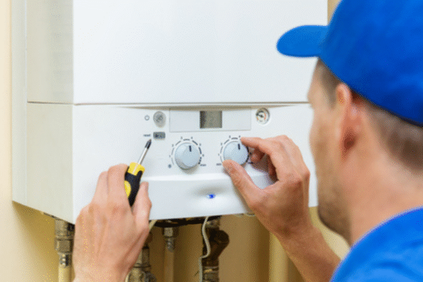 man fixes boiler