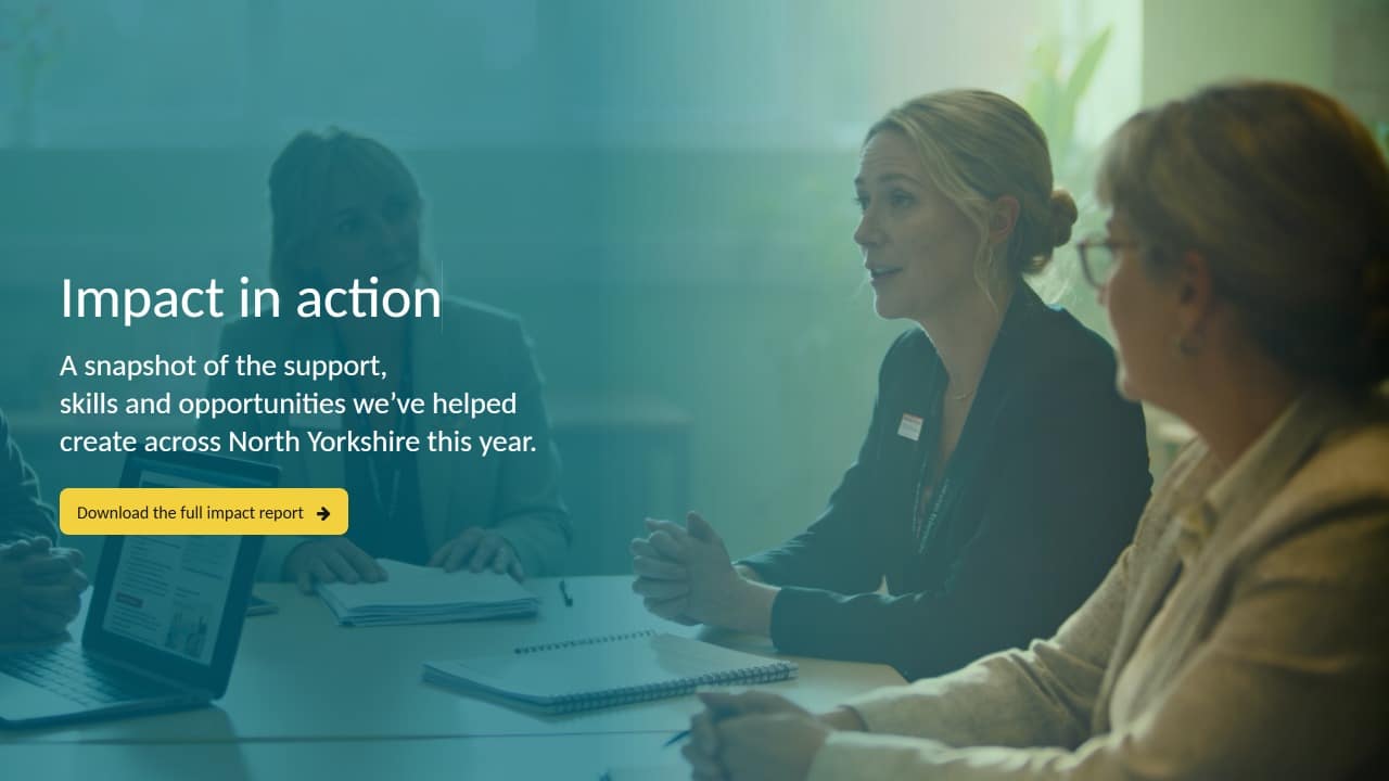 Three women in business attire sit at a table in discussion, with notebooks and a laptop. Text overlay reads, Impact in action, and promotes downloading a full impact report for North Yorkshire.
