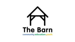 A simple black barn outline sits above the words The Barn. Below, community.education.youth is written—each word in blue, green, and yellow respectively—to reflect the vibrant spirit of Tadcaster Barn.