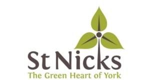 St Nicks logo with three green leaves forming a heart shape above the text St Nicks and the tagline The Green Heart of York below, representing the charity’s central role in York’s environmental community and its commitment, guided by the Charity Operations Manager, to sustainability.
