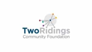 Logo for York-based Two Ridings Community Foundation, featuring stylised connected dots and lines above the name. The words Two Ridings are bold, with Two in blue, Ridings in grey, and Community Foundation below—reflecting the organisation’s commitment as a leading Grants Administrator in the region.